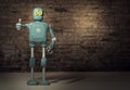 Retro vintage robot show tumb up; on a brick wall background Royalty Free Stock Photo