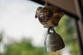 Retro or vintage style metal door bell hanging on the door in focus. Decorative retro objects. brass bell hand on to the window on Royalty Free Stock Photo