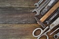 Retro vintage woodwork equipment set. Hammer scissors screwdriver on brown texture wooden planks background. Old Royalty Free Stock Photo