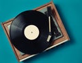 Retro vinyl player on a blue background. Entertainment 70s. Listen to music.
