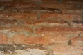 Retro wall of broken obsolete bricks, soft focus