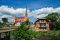 Retro water mill and old church of Holy Trinity in Gerviaty on background, Grodno region, Belarus Royalty Free Stock Photo