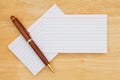 Retro white paper index cards with pen on wood desk Royalty Free Stock Photo
