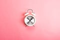 Retro white and silver alarm clock on a pink background Royalty Free Stock Photo