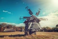 Retro windmill on rural landscape.