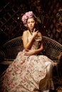 Retro woman. Girl in vintage style with flowers in hairstyle Royalty Free Stock Photo