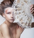 Renaissance. Vintage. Genuine Delightful Woman holding Old-Fashioned Classic Fan