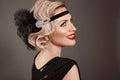 Retro woman portrait. Blonde wavy hairstyle. Hollywood red lips makeup. Curly hair style. Beautiful elegant female wears in Royalty Free Stock Photo