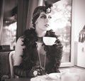 Retro Woman 1920s - 1930s Sitting with Cup of Tea Royalty Free Stock Photo