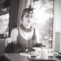 Retro Woman 1920s - 1930s Sitting with Cup of Tea Royalty Free Stock Photo