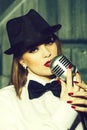 Retro woman singing into microphone Royalty Free Stock Photo