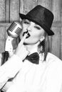 Retro woman singing into microphone Royalty Free Stock Photo