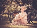 Retro woman sitting on a meadow