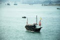 Retro wooden ship or Chinese junk boats in Victoria Harbour in Hong Kong, China