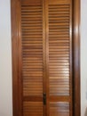 Retro wooden slatted bifold folding closet doors in wood