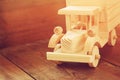 Retro wooden toy car over wooden table. room for text. nostalgia and simplicity concept. retro style image