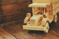 Retro wooden toy car over wooden table. room for text. nostalgia and simplicity concept. retro style image Royalty Free Stock Photo