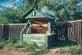 Retro wooden water well in village. Royalty Free Stock Photo
