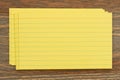 Retro yellow paper index cards stack on wood desk Royalty Free Stock Photo