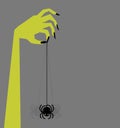 Retro zombie hand holding creepy swinging spider, with space for text.