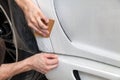 Retrofitting the car with a solid transparent protective film, the master glues the coating protecting the vehicles from scratches Royalty Free Stock Photo