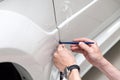 Retrofitting the car with a solid transparent protective film, the master glues the coating protecting the vehicles from scratches Royalty Free Stock Photo