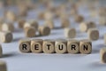 Return - cube with letters, sign with wooden cubes