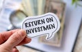 Return on Investmen text on white card on the chart background Royalty Free Stock Photo