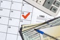 1065 Return of partnership income blank with dollar bills, calculator and pen on calendar page with marked 15th April Royalty Free Stock Photo