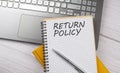 RETURN POLICY text written on a notebook on the laptop,business