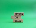 Return on Sales symbol. Concept word Return on Sales on wooden blocks. Beautiful green background. Business and Return on Sales Royalty Free Stock Photo