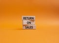 Return on Sales symbol. Concept word Return on Sales on wooden blocks. Beautiful orange background. Business and Return on Sales Royalty Free Stock Photo