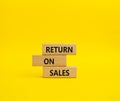 Return on Sales symbol. Concept word Return on Sales on wooden blocks. Beautiful yellow background. Business and Return on Sales Royalty Free Stock Photo