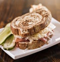 Reuben sandwich with kosher dill pickle and coleslaw Royalty Free Stock Photo