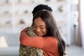 Reunion Concept. Beautiful Happy Black Woman Embracing Military Husband At Home Royalty Free Stock Photo