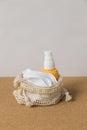 Reusable bamboo cotton pads for make-up remover in a bag, another yellow bottle with lotion for make-up remover lie on a natural Royalty Free Stock Photo