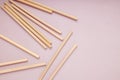 Reusable bamboo straws on the pink background,