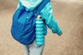 Reusable blue eco friendly water bottle on child`s backpack