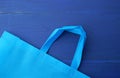 Reusable blue viscose bag on blue wooden background