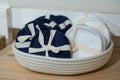 Reusable blue and white cotton pads, discs in knitted basket in bathroom.