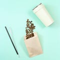 Reusable eco coffee cup, metal drinking straw, roasted coffee beans in papaer bag Royalty Free Stock Photo