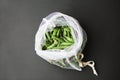 Reusable eco-friendly bag full of fresh seasonal pea pods on black background Royalty Free Stock Photo