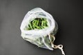 Reusable eco-friendly bag full of fresh seasonal pea pods on black background Royalty Free Stock Photo