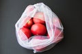 Reusable eco-friendly bag full of fresh seasonal tomatoes on black background Royalty Free Stock Photo