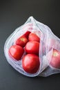 Reusable eco-friendly bag full of fresh seasonal tomatoes Royalty Free Stock Photo