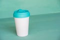 Reusable eco-friendly bamboo cup on mint green background Royalty Free Stock Photo