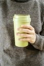 Reusable eco friendly bamboo cup for take away coffee close up in womans hands Royalty Free Stock Photo