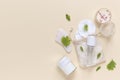 Reusable glass white bottles for oil, cream, lotion or serum, reusable cotton pads and a gouache scraper on a beige Royalty Free Stock Photo