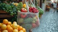 Reusable net bag filled with fresh fruits and vegetables at a local market Royalty Free Stock Photo