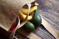 Reusable shopping bag with fresh fruits. Natural eco friendly material. Yellow bananas, green avocado, hessian or jute sack